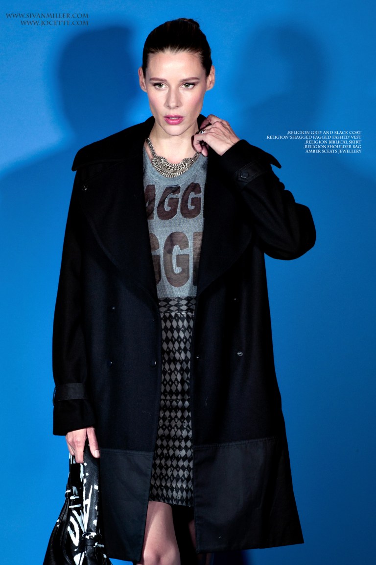 Jocette Wears RELIGION Grey and Black Coat, RELIGION Shagged Fagged Fashed Vest, RELIGION Biblical Skirt, RELIGION Shoulder Bag, AMBER SCEATS Jewellery